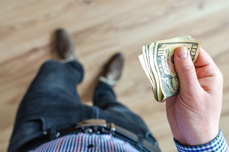one person, business, body part, savings, paper currency, economy, young, jeans, holds, wealth, s, finance, human hand, low section, wear, fingers, money