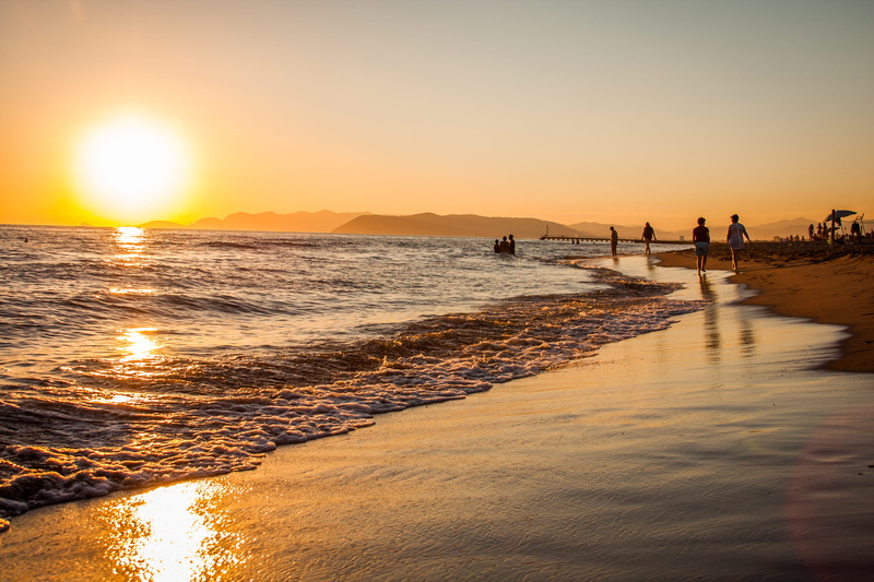 sand, people, sunset, sky, hour, swimming, landscape, waves, horizon over water, golden, trip, tranquility, mountains, water, outdoors, vacations, seashore