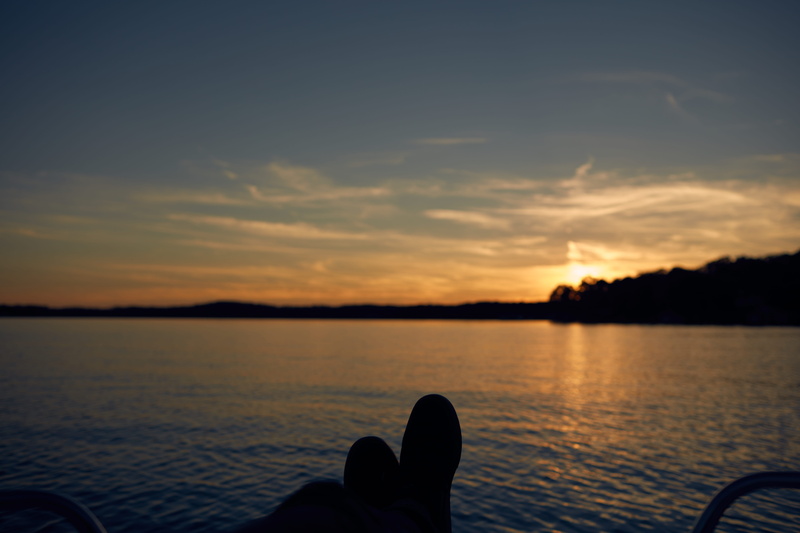 shoes, cloud - sky, human limb, relax, human leg, shoe, sea, real people, smith mountain lake, sunset, water, leisure activity, silhouette, lake, body part