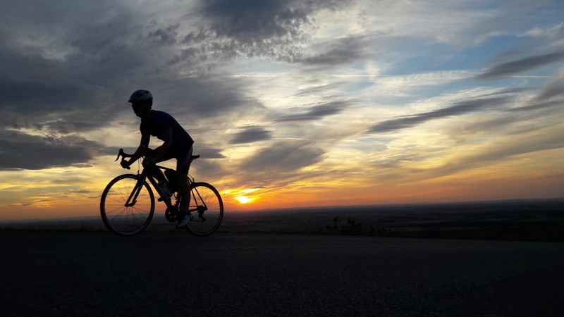 wheels, cloud - sky, silhouette, bicycle, mode of transportation, one person, sky, land vehicle, race, beauty in nature, transportation, shadow, sport