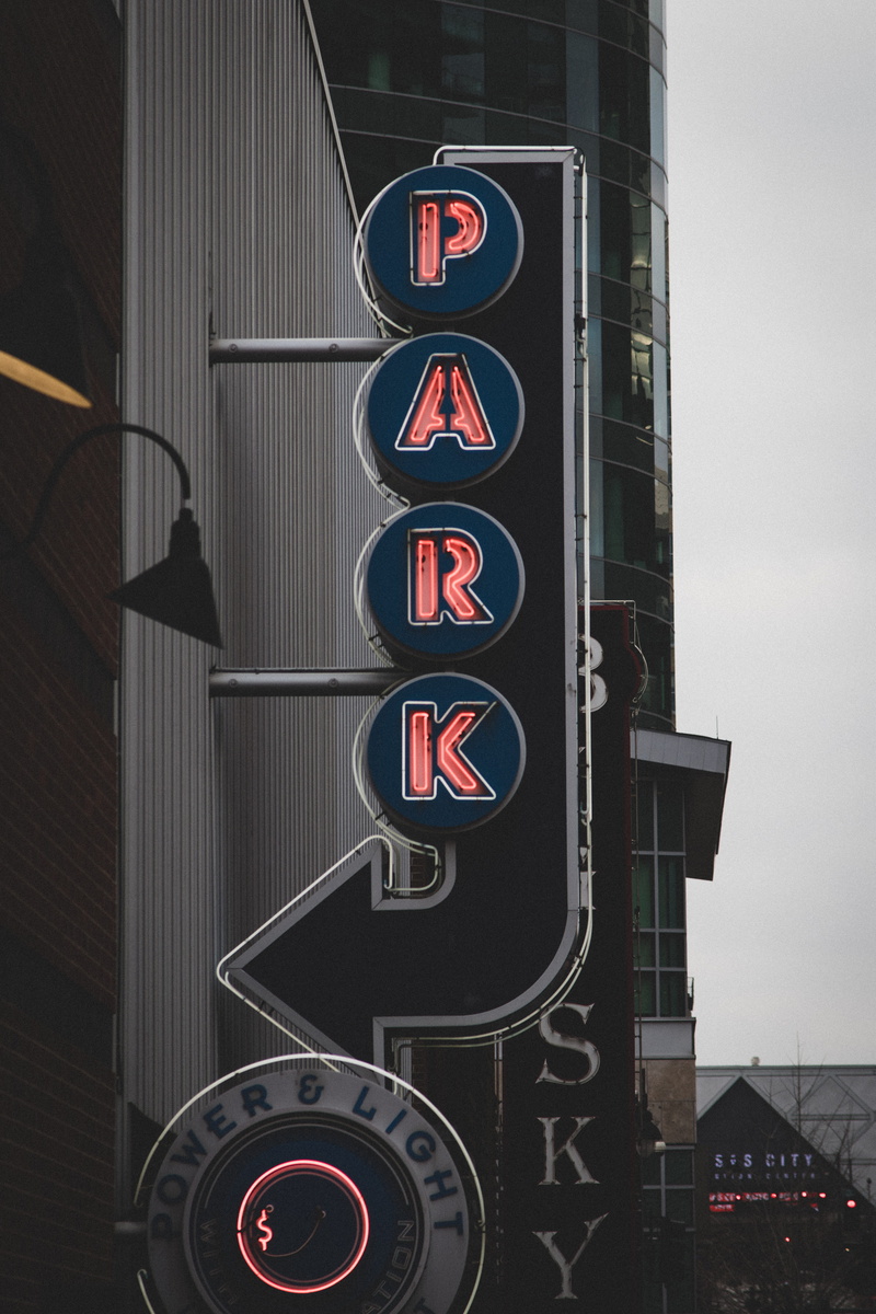 day, park, sign, text, road sign, illuminated, built structure, night time, signage, light, design, outdoors, western script, signalise, graphic, circle