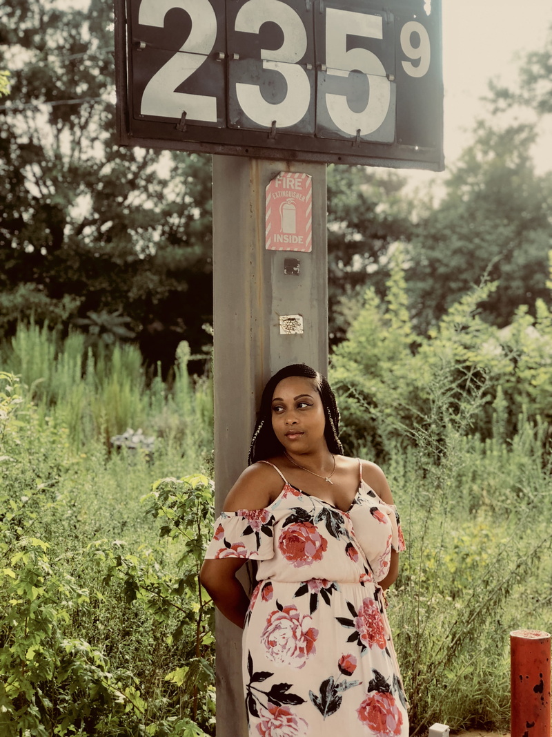 post, looking at camera, tree, casual clothing, sign, 4K, signalise, near, young women, outside, leisure activity, wear, grass, day, one person, front view