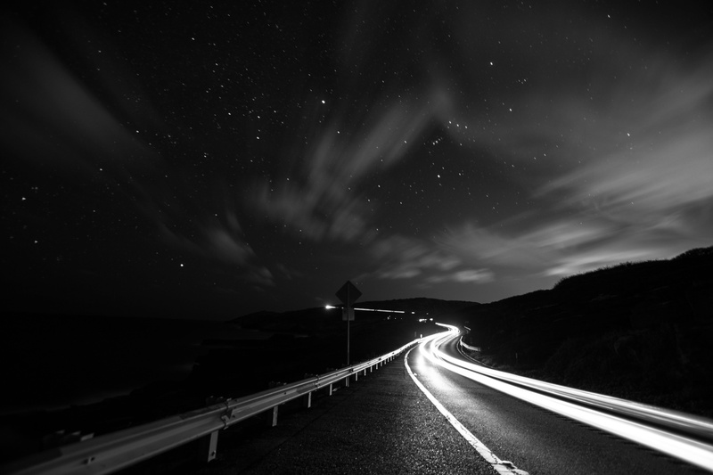 timelapse, outdoors, cloud - sky, star - space, diminishing perspective, vanishing point, street, the way forward, light trail, highway, no people, grayscale