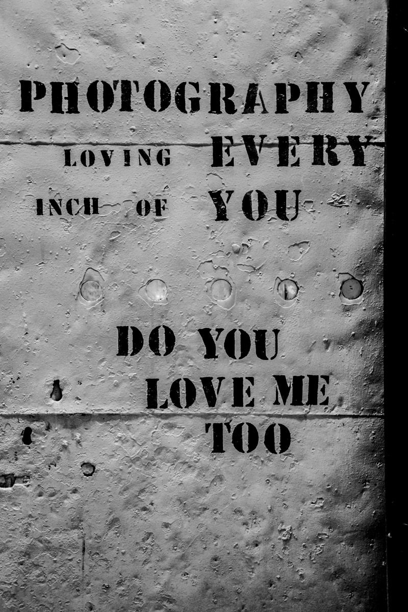 advertisement, day, tombstone, built structure, gray, capital letter, alphabet, western script, clothing, background, message, architecture, close-up, concrete
