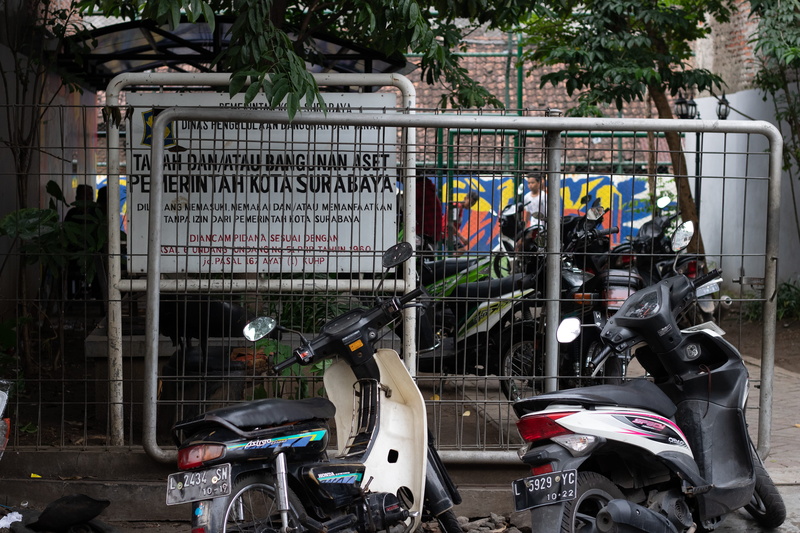 tree, outdoors, motor scooter, no people, motor vehicle, scooter, bicycle, large group of objects, parking lot, motor cycle, built structure, metal, mode of transportation
