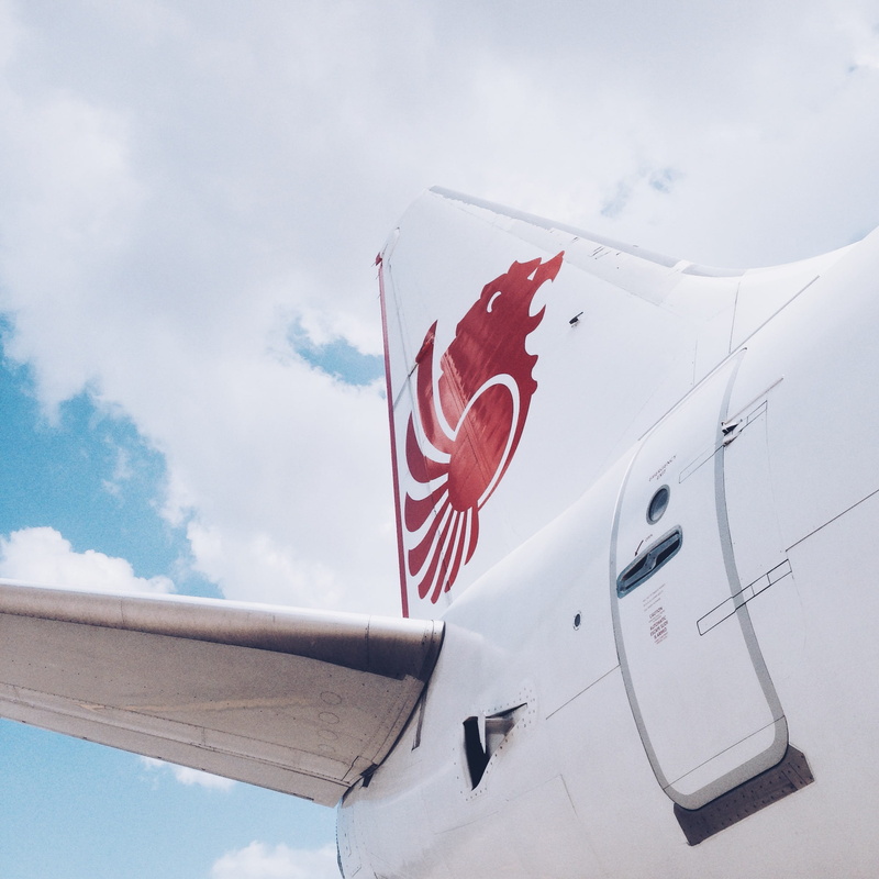aircraft, low angle view, machine, vehicle, jl. bandara hang nadim, air vehicle, city, sky, white, warplane, airliner, no people, transportation, mode of transportation
