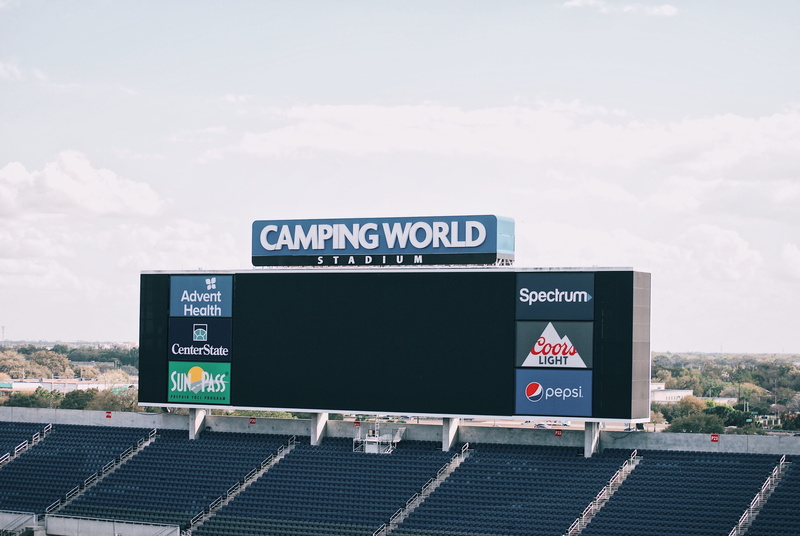 built structure, road, billboard, rural, non-western script, no people, nature, advertisement, text, cloud - sky, western script, countryside, stadium