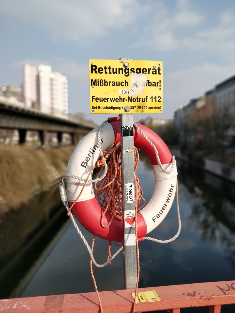 ring, security, water, text, built structure, symbol, vehicle, inflatable, railing, pier, vessel, plaque, architecture, clothing, communication, white