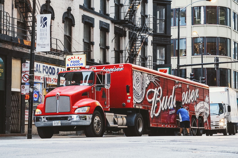 daytime, vehicle, motor vehicle, day, transport, trailer, store, built structure, transportation, delivery, parked, king of beer, land vehicle, incidental people