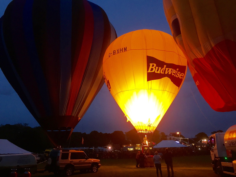 transport, illuminated, incidental people, air vehicle, mode of transportation, sky, 2K, outdoors, traditional festival, low angle view, hot, budweiser