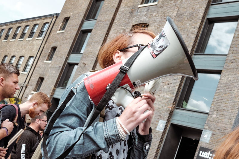 group of people, megaphone, arts culture and entertainment, young adult, playing, young women, adult, urban, holding, male, female, men, person, day, man