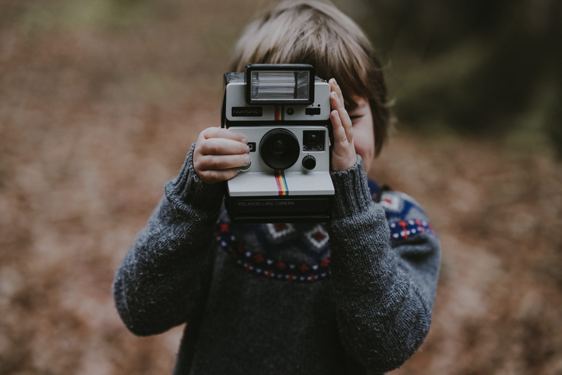 kid, casual clothing, photo, boy, using, childhood, polaroid, focus on foreground, obscured face, photographer, 8K, portrait, outdoors, blond hair, warm clothing