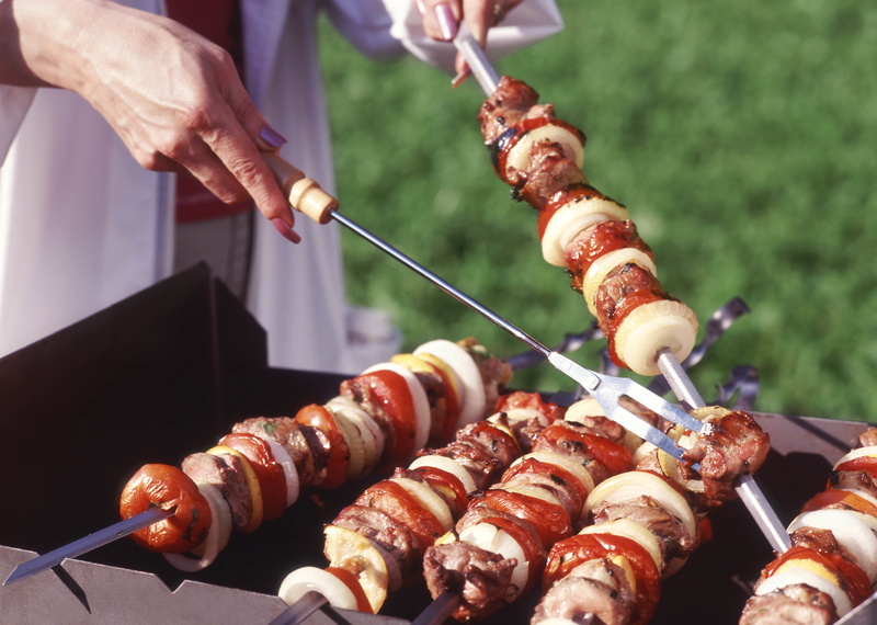 hands, stick - Plant Part, outdoors, barbecue, preparation, sausage, summer, grilled, roasted, day, one person, skewers, heat - Temperature, hand, refreshment