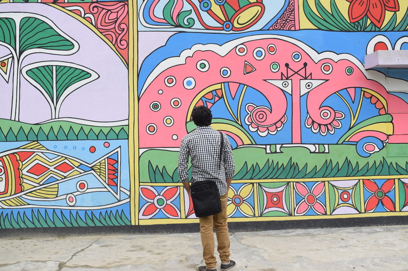 one person, village, design, pattern, built structure, mural, spot, full length, leisure activity, standing, lifestyles, creativity, tourism, landscape