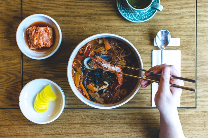 food, table, kitchen utensil, soup, glass, Korean, holding, spoon, high angle view, breakfast, finger, bowl, meal, chopsticks, 5K, wood, hand, freshness