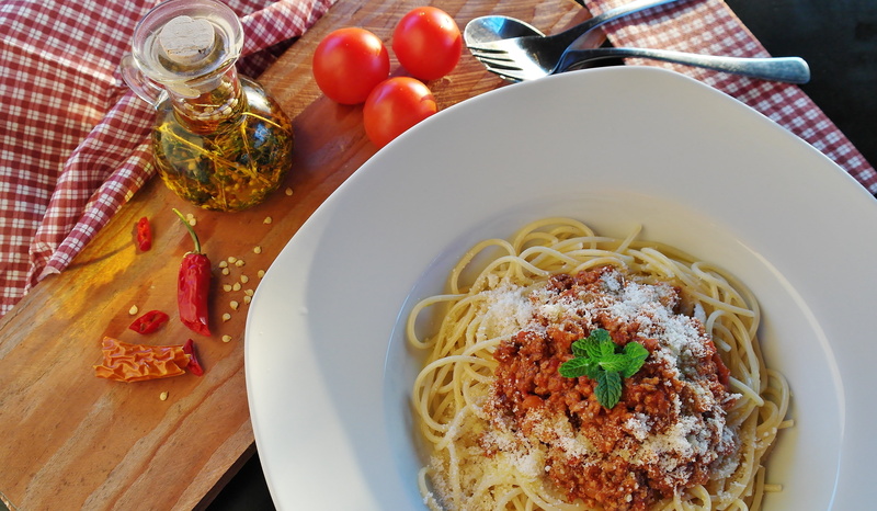oil, table, food, high angle view, no people, glass, garnish, carbohydrates, plate, italian food, crockery, eat, olive oil, tomatoes, vegetable, nutrition