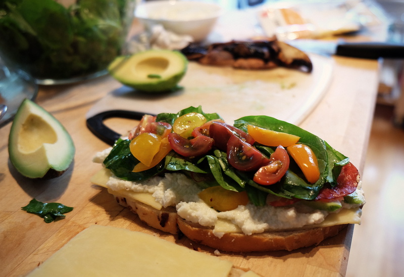 oil, cheese, antipasti, ready-to-eat, appetizer, vegetable, sandwich, vegetables, lettuce, tomato, cutting board, tasty, plate, delicacy, prepared, no people