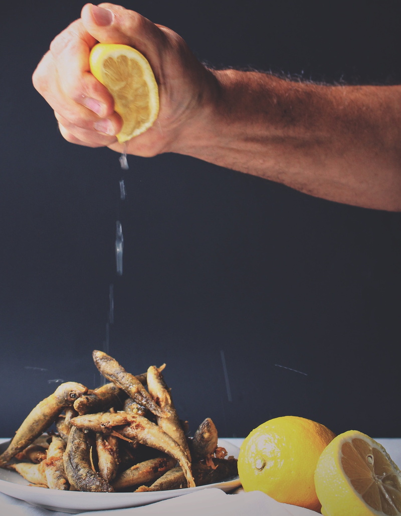 food, black background, one person, men, snack, fishes, real people, 2K, squeezing, citrus fruit, wellbeing, lemon, gourmet, preparing food, preparation