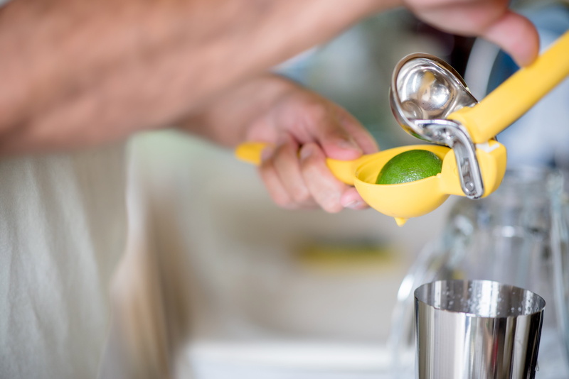 holding, indoors, blurred background, close-up, container, drink, juice, 5K, plastic, refreshment, food and drink, yellow, household equipment, hand, women