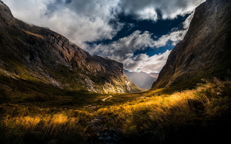 remote, dirt road, environment, nature, mountain range, clouds, no people, tranquil scene, day, shrubs, sun rays, yellow, tranquility, beauty in nature