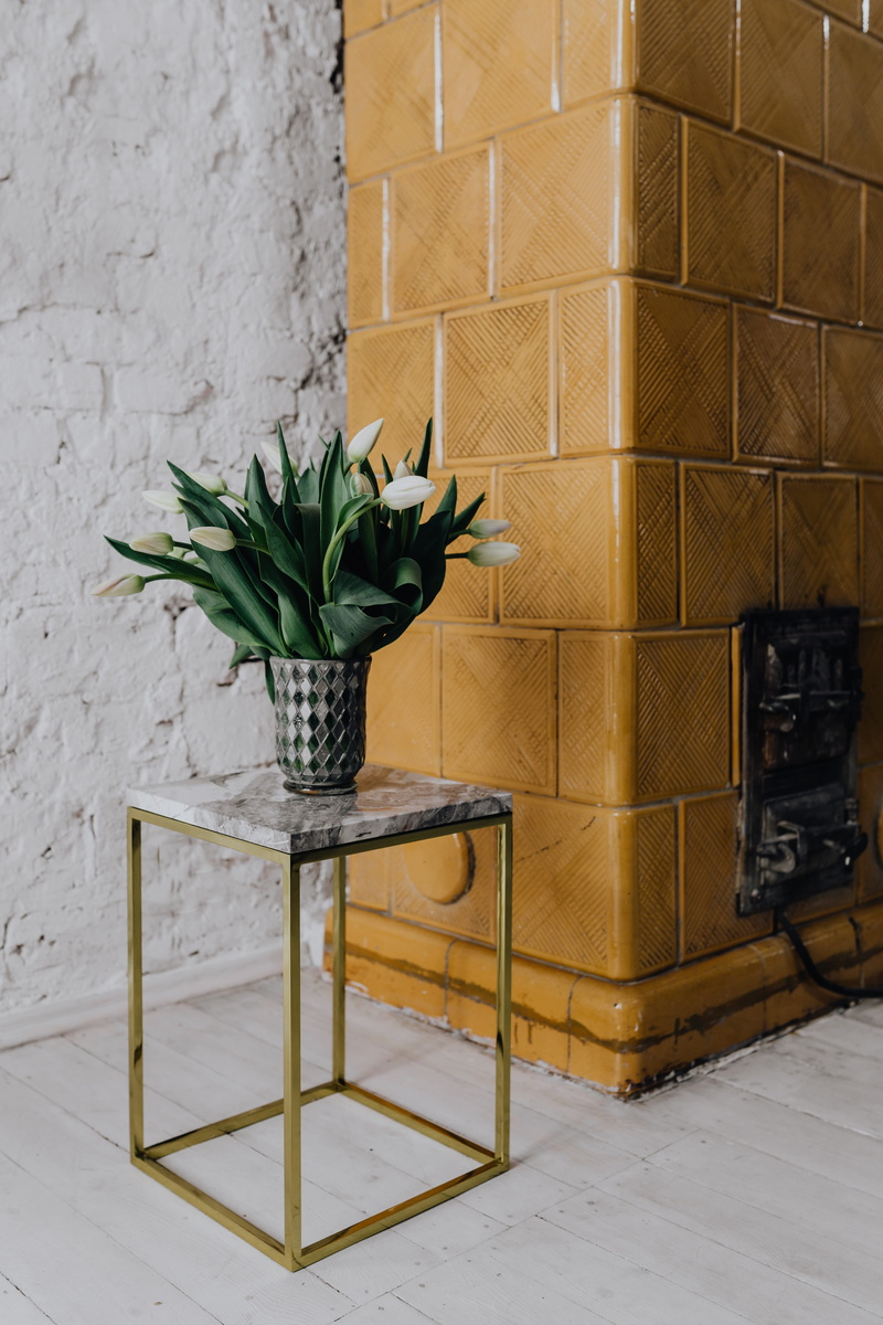 potted plant, wall, room, flowering plant, wall - building feature, white walls, seat, vulnerability, chair, white floor, marble table, living room, flooring