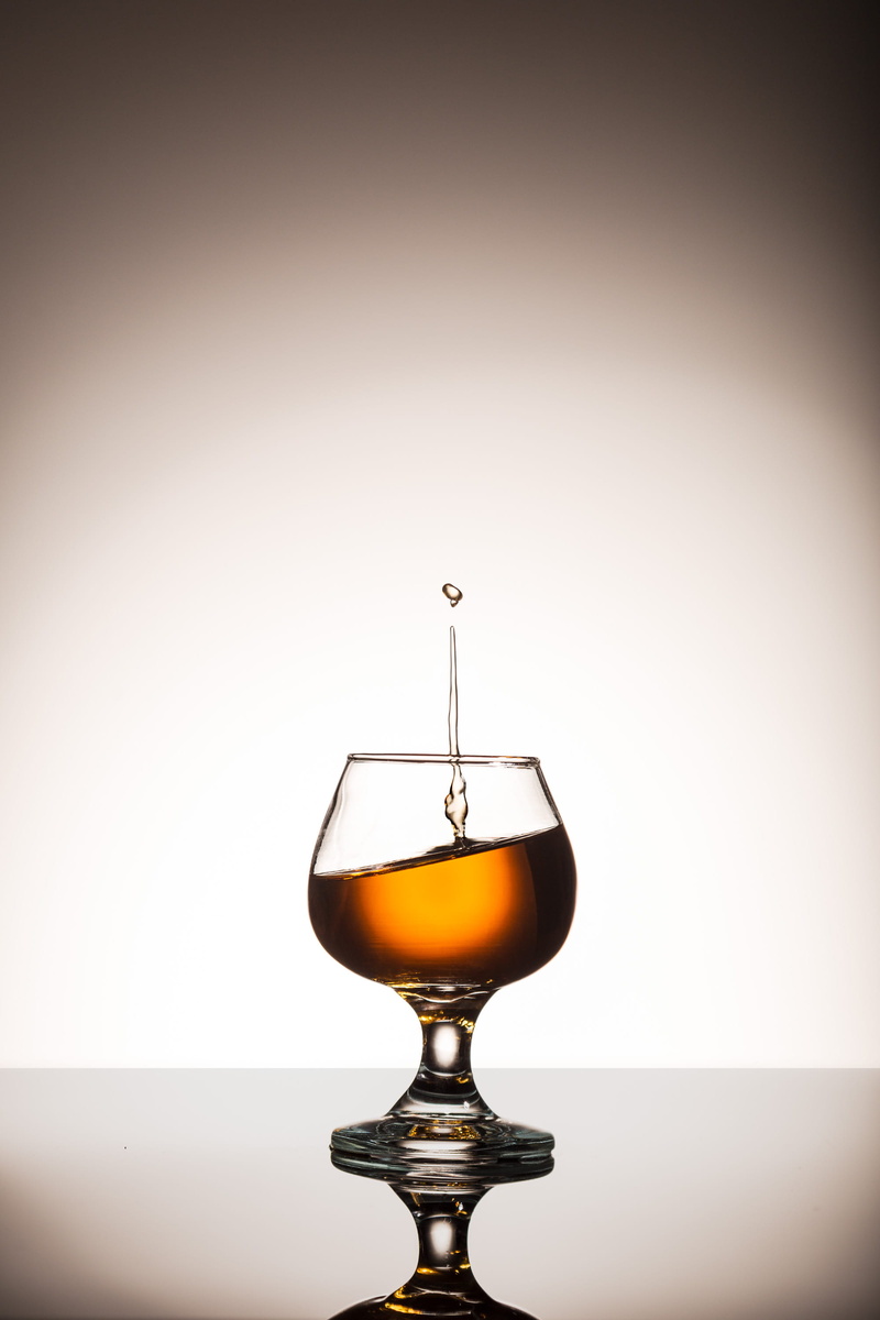 studio shot, cognac, freshness, 2K, dropplet, liquid, glass - material, indoors, lighting equipment, liquor, food and drink, single object, food, reflection