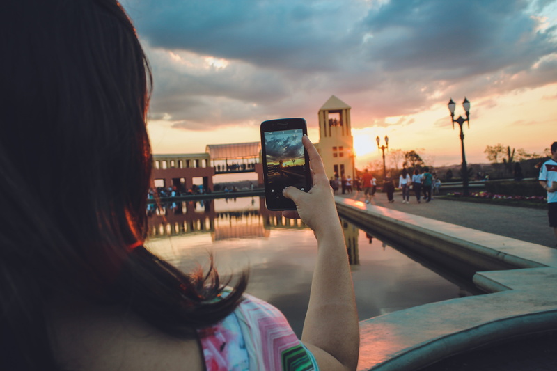activity, urban, taking photo, lights, communication, technology, lamp posts, mode of transportation, adult, people, connection, park, architecture, cellphone