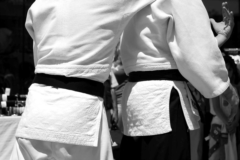 display, incidental people, city, rear view, grayscale, sport, competition, fight, people, taekwondo, sporting event, casual clothing, togetherness, sports