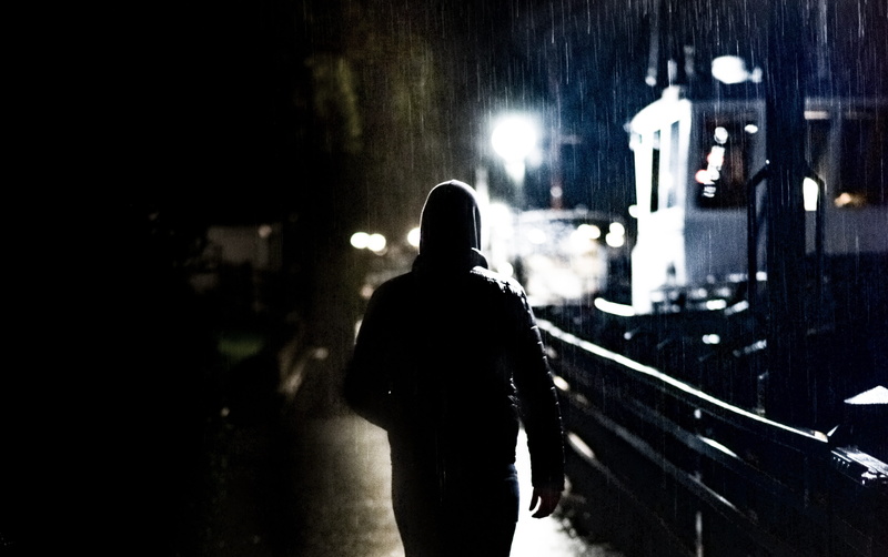 city life, vehicle, adult, dark, built structure, rear view, man, rain, one person, real people, silhouette, architecture, building exterior, people, illuminated