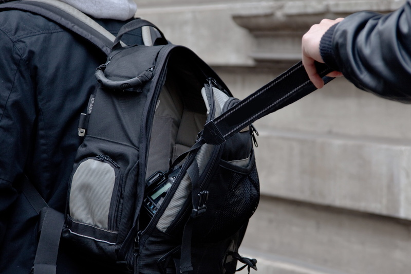 gun, camera theft, government, day, strap, rob, focus on foreground, clothing, Camera, one man only, person, holding, outdoors, weapon, 5K, gang of thieves