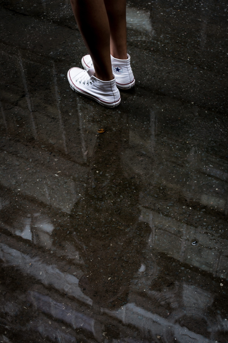human limb, shoe, body part, puddle, converse, street, human leg, low section, real people, wet, sneakers, high angle view, wearing, feet, pair, shallow