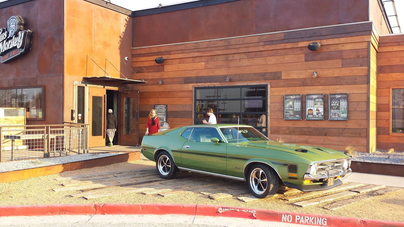 green, vintage car, real people, car, land vehicle, residential district, motor vehicle, sunlight, men, mode of transportation, building, street, built structure