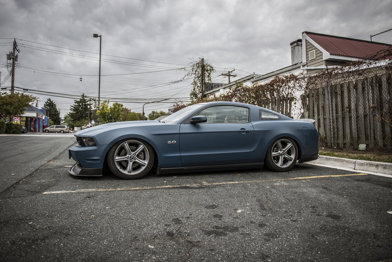 blue, built structure, nature, tuning, road, vehicle, motor vehicle, outdoors, land vehicle, day, street, blue cars, Ford Mustang, stationary, no people