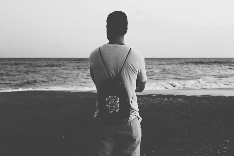 drawstring, men, horizon over water, lifestyles, sand, people, sea, scenics - nature, horizon, beach, leisure activity, bag, one person, outdoors, back