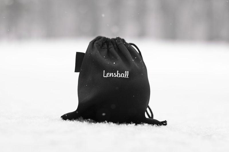close-up, snowing, no people, selective focus, white, covering, focus on foreground, snow, black, western script, 5K, communication, text, mammal, bag