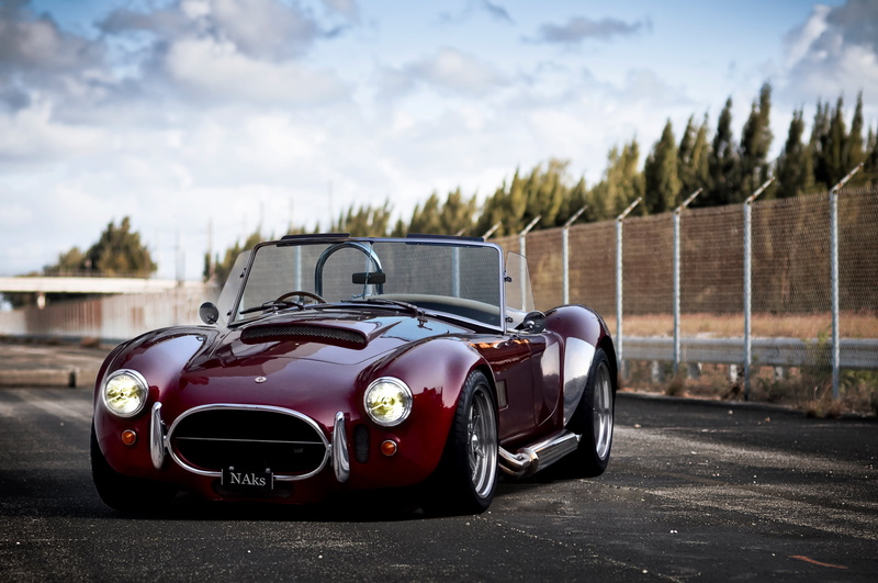 AC Cobra, car, sky, retro, tree, oldtimer, retro styled, mode of transportation, black color, style, convertible, luxury, land vehicle, motor vehicle, focus on foreground