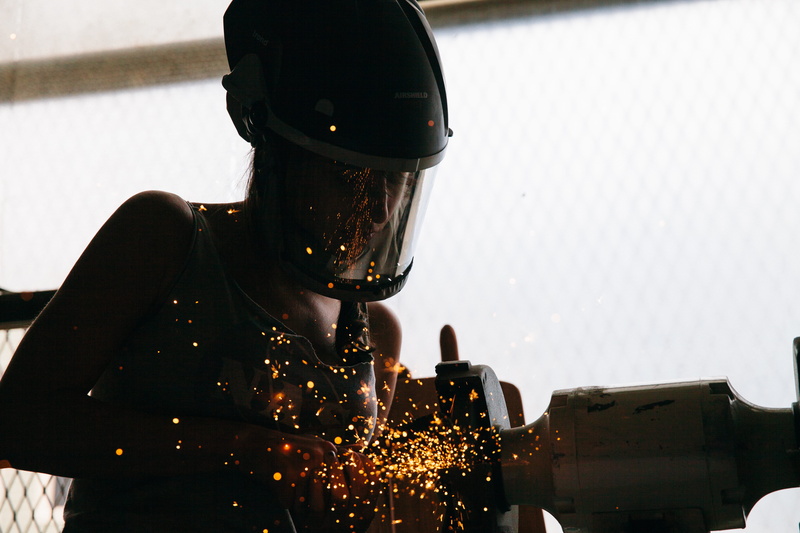leisure activity, city, welder, portrait, real people, protection, headwear, sparks, crash helmet, one person, transportation, machine, waist up, obscured face