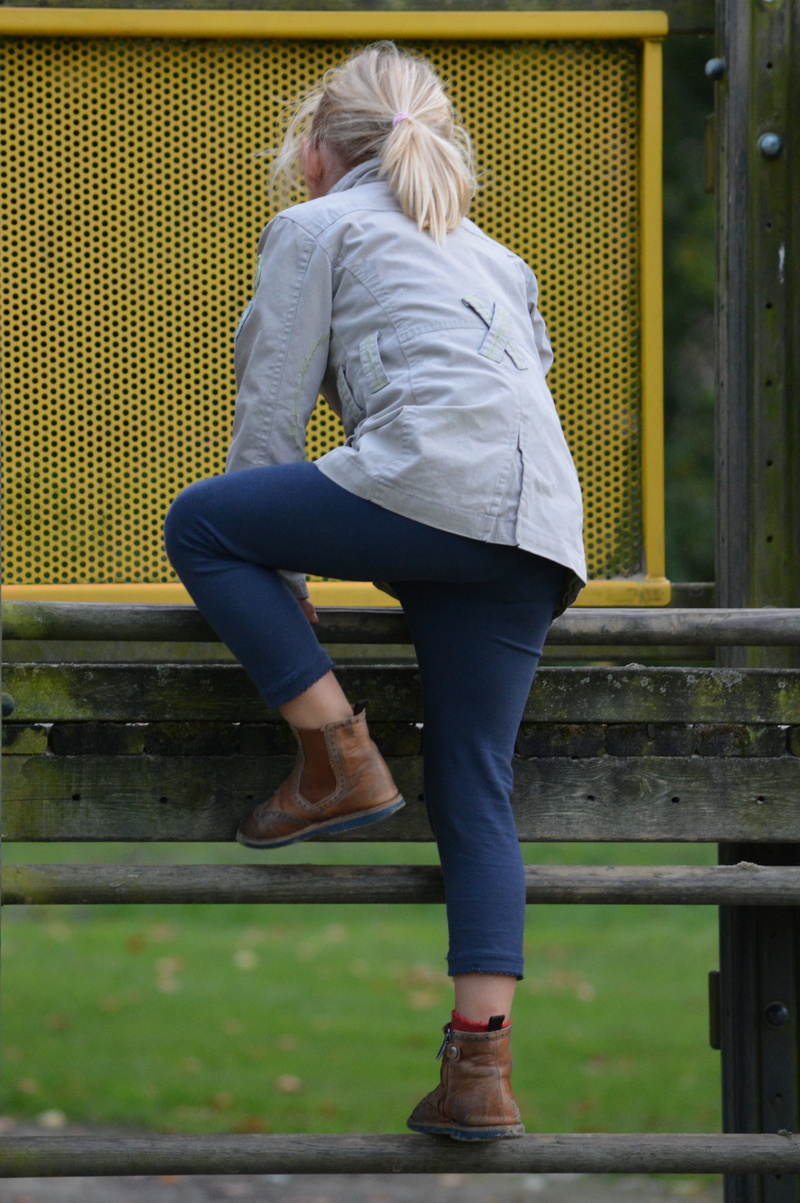 climbing, rear view, casual clothing, day, females, people, built structure, lifestyles, childrens playground, adult, leisure activity, full length, railing