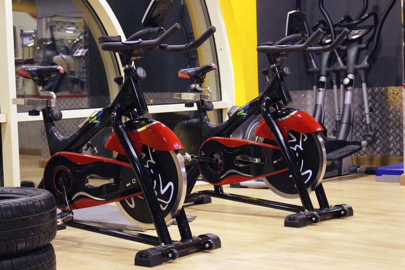indoors, exercise equipment, machinery, Fitness, exercising, bikes, wheel, black, seat, training, weight training, mode of transportation, exercise, no people