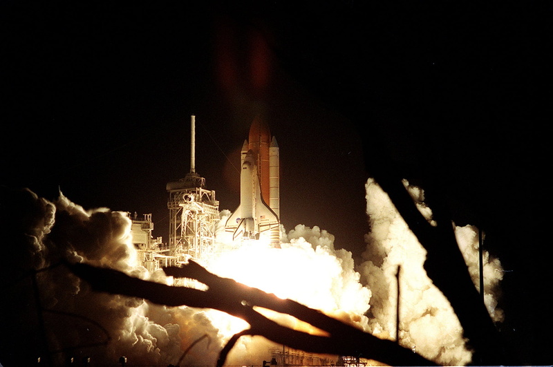 lighting equipment, industry, building exterior, smoke stack, no people, launching, outdoors, space shuttle, light - natural phenomenon, smoke - physical structure