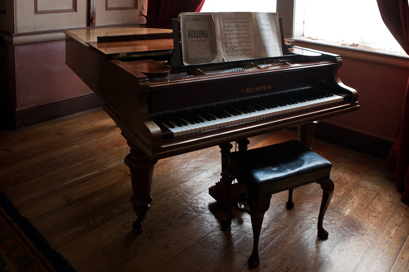 oak flooring, sheet music, near, no people, wood, indoors, hardwood floor, playing, piano key, keyboard, music, musical equipment, piano, seat, arts culture and entertainment