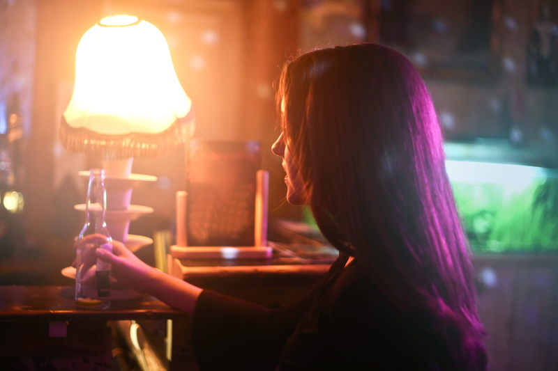 lamp, drinking, bar - drink establishment, one person, long hair, Adult, Alcohol, food and drink, colourful lights, woman, front, caucasian, Bottle, portrait