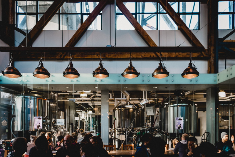 lighting equipment, pub, hanging, large group of people, business, factory, vase, real people, skylight, men, human, jar, architecture, manufacturing, person