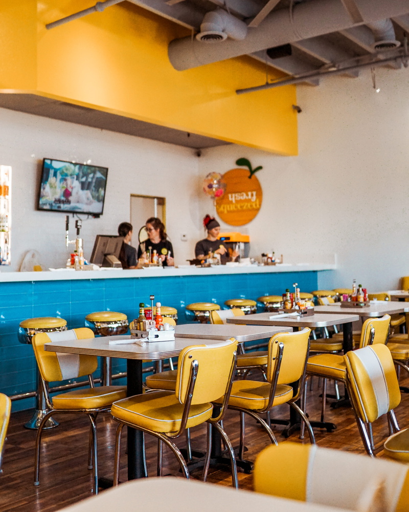 interior, blue, behind, cafeteria, standing, electric lamp, vintage, diner, adult, white, bright, women, food, brunch, chair, cafe, food and drink industry