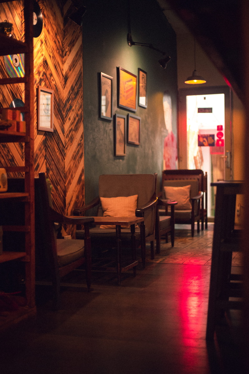 wall - building feature, chair, restaurant, tables, built structure, door, light, domestic room, interior, living room, indoors, table, lamp, coffee shop