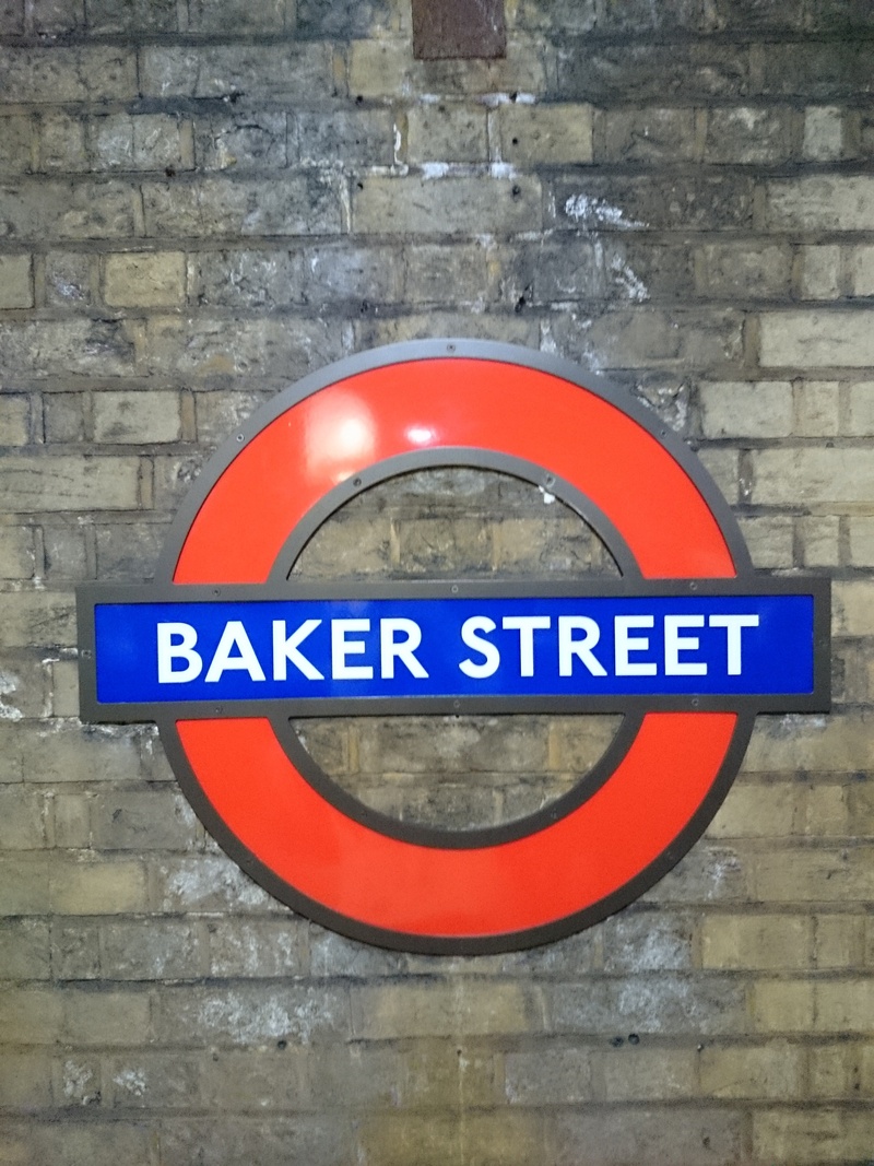 brick wall, built structure, text, architecture, wall - building feature, western script, day, circle, 2K, brick, sign, information sign, road sign, geometric shape