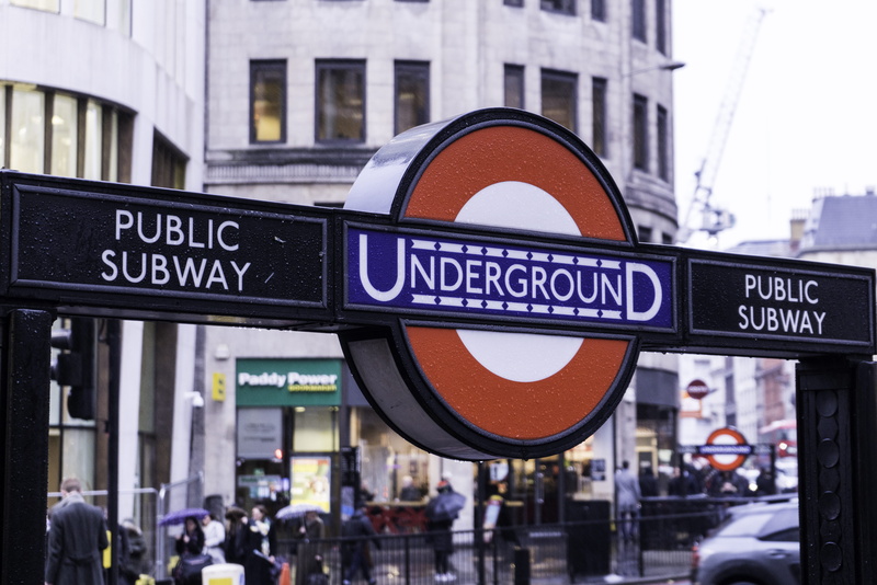 incidental people, day, road sign, communication, transport, focus on foreground, travel destinations, information, city life, road, underground, street