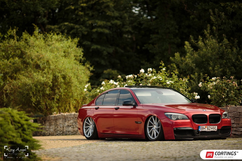 land vehicle, BMW 7 Series, plant, nature, focus on foreground, mode of transportation, red, sunlight, day, GajuKYD, outdoors, Vossen CVT, no people, green color