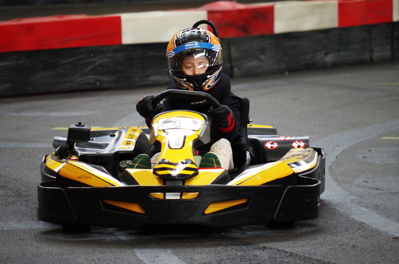 race, crash helmet, headwear, motor racing track, outdoors, professional sport, kart, racer, sports helmet, mode of transportation, helmet, go, boy, motorsport