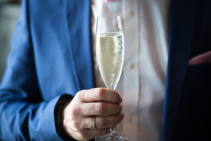 real people, men, anniversary, focus on foreground, glass, sparkling, alcohol, 5K, unrecognizable person, blur, hand, champagne flute, luxury, drinking